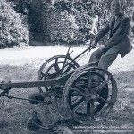 John Heartfield playfully riding a farm implement